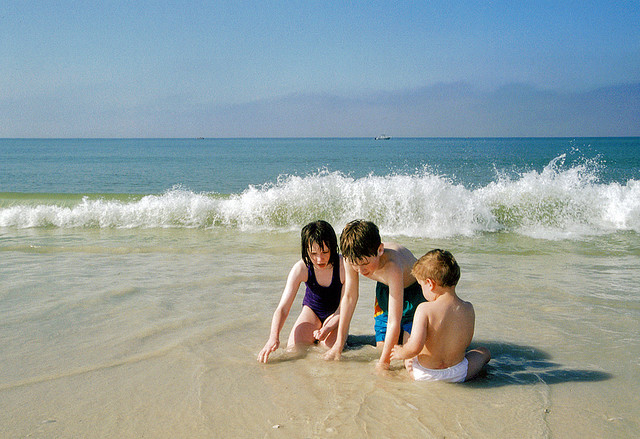 Kids finding treasures on a Florida Gulf Coast beach near Naples (courtesy tlindenbaum at Flickr CC)