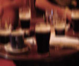 blurry picture of pints on a table in an Irish pub