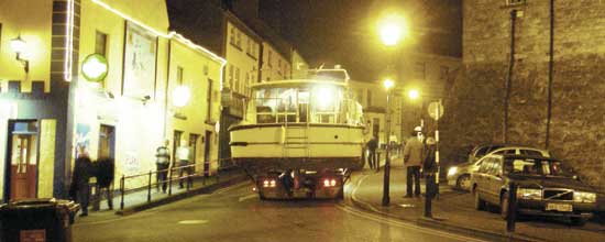 boat being transported through athlone town on the back of a lorry near sean's bar, athlone