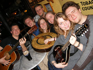 Exchange students from the Athlone Institute of Technology holding Irish instruments at the Shack tuesday music session