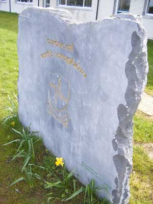 stone monument out front of the school reading ardscoil rath Iomghain