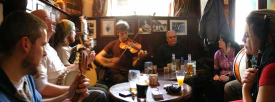 musicians sit around the tables at Sean's Bar Sunday session in Athlone