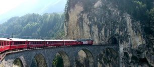 scenic eurorail pic of train on stone trestle entering a mountain