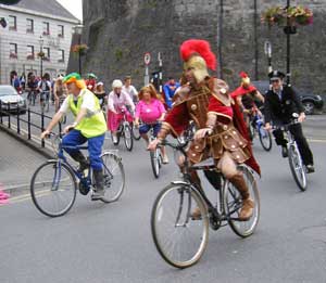 costumed athlonians biking past Sean's Bar for the Chernobyl charity project