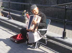 Roma accordianist plays outside Athlone Castle