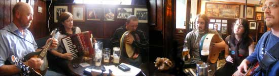 musicians gathered around the table at a traditional Irish session in Sean's Bar, Athlone