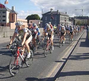 bicyclists in the tour of ireland race pass over the athlone town bridge