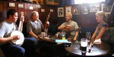 musicians gathered around the table at a traditional Irish session in Sean's Bar, Athlone